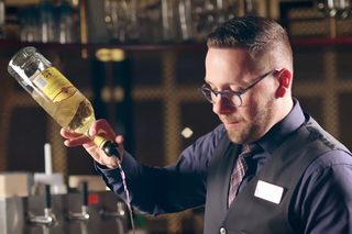 Delicate paper lanterns hang from a branch, softly illuminated against a modern, airy backdrop with subtle lines and natural elements.