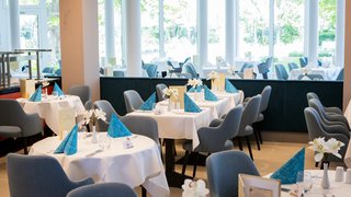 Cheers with a variety of colorful cocktails, showcasing a festive gathering among friends at a stylish dining setting.