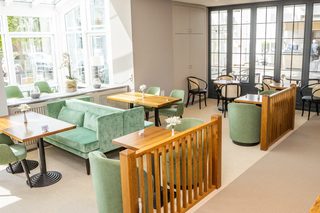 A chic retail space features glass walls, inviting entrance, and displays of products, creating an enticing atmosphere for shoppers.